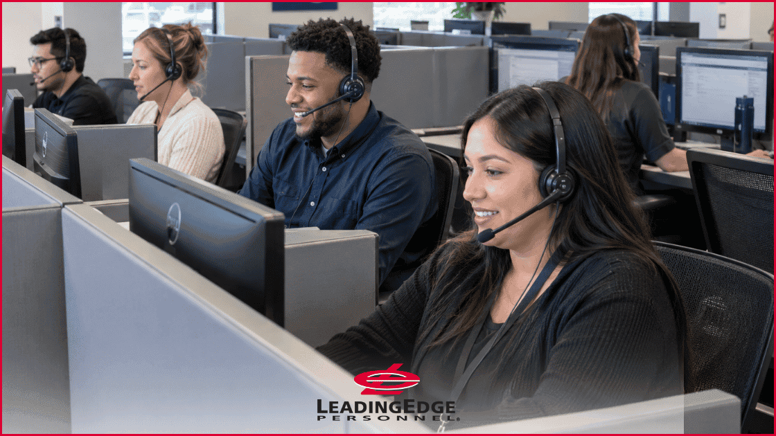 a line of people in an administrative office at computers, each with headpieces for their phones, with the LeadingEdge Personnel logo over the image in the center bottom.