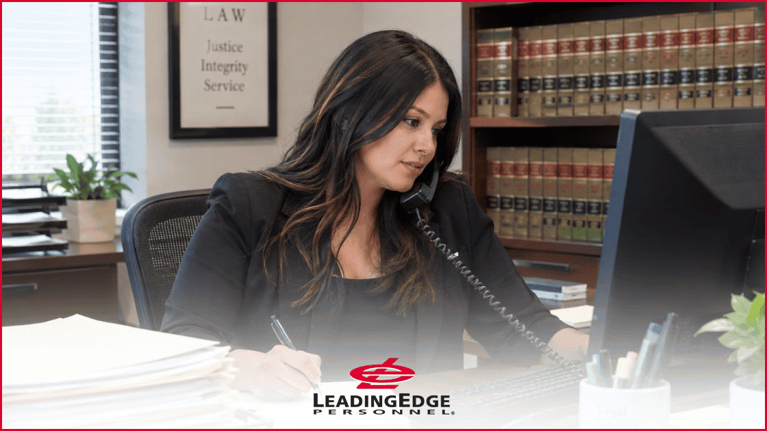 woman on the phone in a law office with the LeadingEdge Personnel logo over the top of the image in the bottom center.